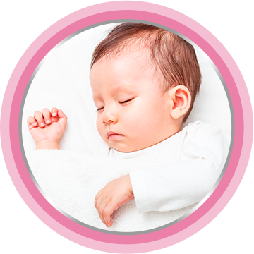 Baby laying on bed after the application of baby cream
